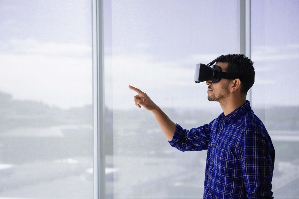 Executive using virtual reality headset in office