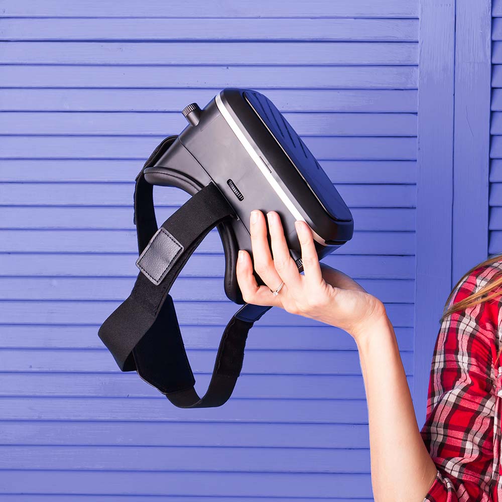 Woman wearing virtual reality goggless. Studio shot